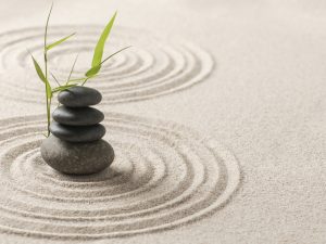 Stacked zen stones sand background art of balance concept
